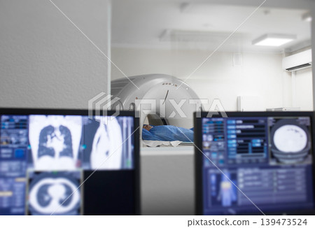 Medical staff operate imaging equipment for patient diagnostics in a modern medical clinic setting Medical staff operate imaging equipment for patient diagnostics in a modern medical clinic setting 139473524