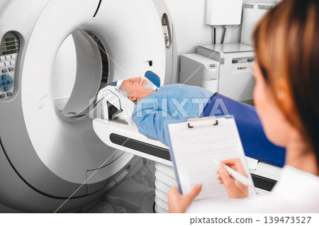 doctor write into medical chart after CT Scan 139473527