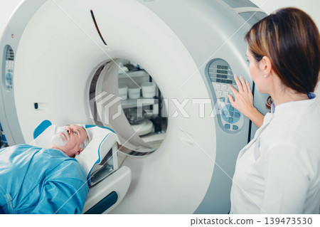 preparing scanner for senior patient , going into CT scanner in hospital 139473530