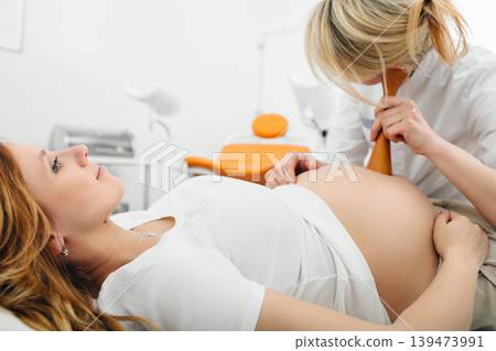 pregnant woman having exam by her obstetrician. prenatal care pregnant woman having exam by her obstetrician. prenatal care 139473991