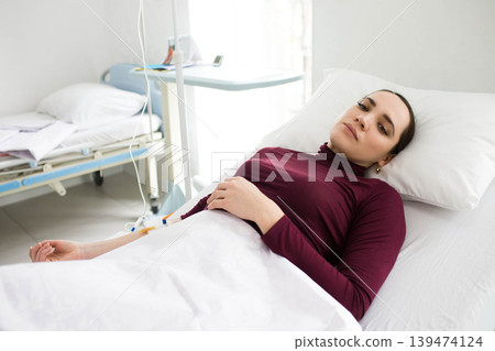 patient having IV drip and lying at hospital ward. Illness 139474124