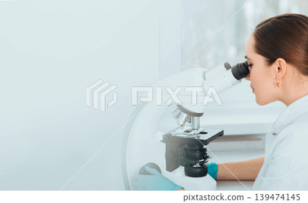 Scientist Looking Through Microscope and concentrate. Biological research Scientist Looking Through Microscope and concentrate. Biological research 139474145