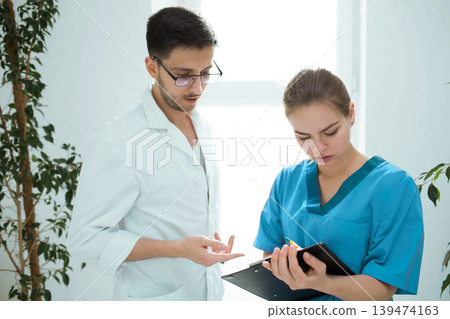Healthcare workers looking into medical documents in the hospital. 139474163