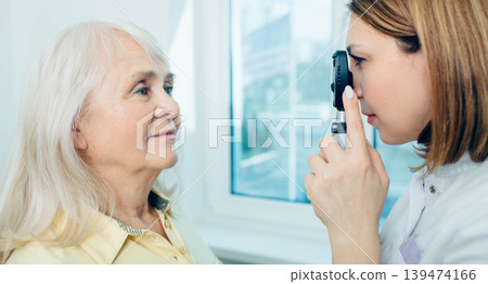 Senior woman doing eye test with eye equipment 139474166