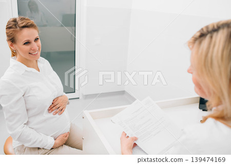 pregnant woman consultation with her obstetrician. Prenatal preparing 139474169