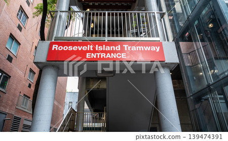 New york, usa august 17,2024. Roosevelt island tramway entrance sign on a manhattan building facade, iconic red landmark connecting midtown east across the east river New york, usa august 17,2024. Roosevelt island tramway entrance sign on a manhattan building facade, iconic red landmark connecting midtown east across the east river 139474391