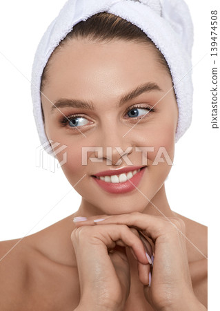 Happy woman with moisturized fresh skin with towel on head after bath procedures. Body care concept 139474508