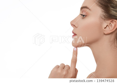 Beautiful woman with perfect skin with lifting arrows on chin line, isolated, side view. Cosmetology procedure for beautiful and elastic face contour Beautiful woman with perfect skin with lifting arrows on chin line, isolated, side view. Cosmetology procedure for beautiful and elastic face contour 139474528