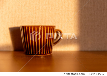 A mug bathed in the setting sun 139474537