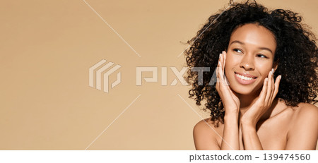Skin care. Beautiful African American woman with healthy facial skin touching hands moisturized face skin, on beige background. High quality Skin care. Beautiful African American woman with healthy facial skin touching hands moisturized face skin, on beige background. High quality 139474560