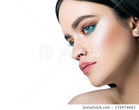 Makeup for blue eyes of a beautiful brunette woman. Trendy individual makeup Makeup for blue eyes of a beautiful brunette woman. Trendy individual makeup 139474662