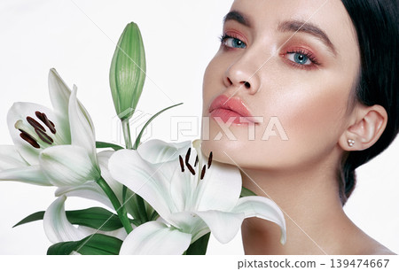 Perfect female face, skin care. Beautiful woman with clean, fresh, healthy skin, isolated on a white background with flower Perfect female face, skin care. Beautiful woman with clean, fresh, healthy skin, isolated on a white background with flower 139474667