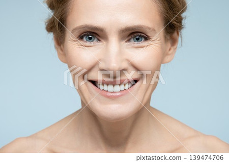 Beauty portrait of middle-age woman with perfect and shiny skin. Concept of skin care and aesthetic cosmetology Beauty portrait of middle-age woman with perfect and shiny skin. Concept of skin care and aesthetic cosmetology 139474706