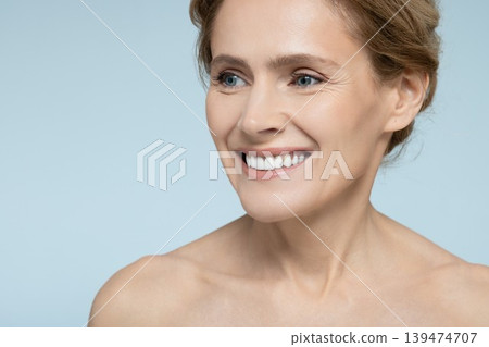 Skin care, beauty portrait. Beautiful mature woman with healthy moisturized facial skin, natural lips and white smile Skin care, beauty portrait. Beautiful mature woman with healthy moisturized facial skin, natural lips and white smile 139474707