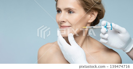 Skin tightening and face contour correction with beauty injections for middle-aging woman's face in cosmetology. Beauty injections Skin tightening and face contour correction with beauty injections for middle-aging woman's face in cosmetology. Beauty injections 139474716