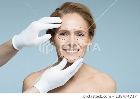 Ideal shape of woman face for plastic surgeon, reference female face on blue background. Plastic surgery, concept 139474737