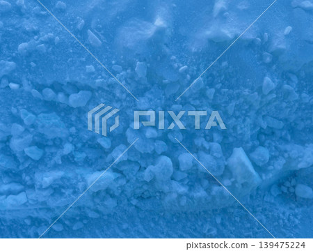 Abstract close up texture of frozen snow and ice crystals with soft blue winter tones. Natural cold background with frosty granular surface and seasonal atmosphere 139475224