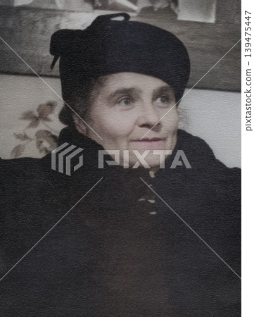 Vintage portrait of a smiling, beautiful elderly woman in a fashionable hat, 1950s. Retro photo, 1956. 139475447