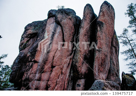 Landscape of Siberia mountains Stolbi, rock Feathers range in haze summer 139475717
