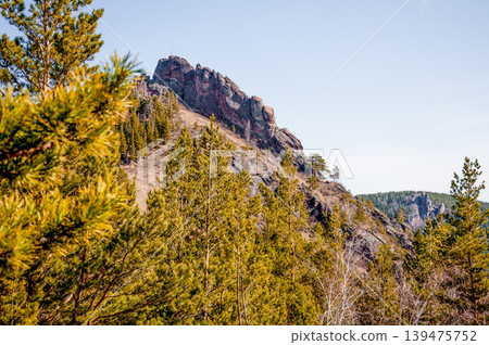 Landscape of Siberia mountains Stolbi, rock peak Takmak range in haze summer Landscape of Siberia mountains Stolbi, rock peak Takmak range in haze summer 139475752