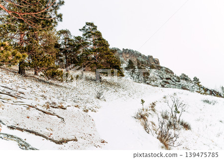 Landscape of Siberia mountains Stolbi, rock peak Takmak range in haze winter Landscape of Siberia mountains Stolbi, rock peak Takmak range in haze winter 139475785