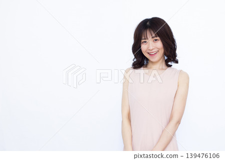 A woman wearing a sleeveless dress 139476106