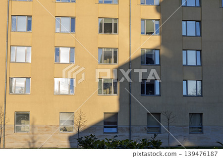 Modern Residential Building Facade with Harsh Diagonal Shadows at Sunset Modern Residential Building Facade with Harsh Diagonal Shadows at Sunset 139476187