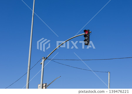 Traffic Light with Red Signal Against Clear Blue Sky 139476221