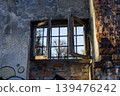 View of Spring Trees Through Old Broken Window of Abandoned Brick Building 139476242