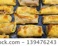 Macro Shot of Golden Brown Toasted Crepe Rolls with Meat Filling 139476243