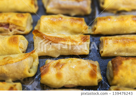 Macro Shot of Golden Brown Toasted Crepe Rolls with Meat Filling Macro Shot of Golden Brown Toasted Crepe Rolls with Meat Filling 139476243