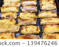 Close-up of Golden Baked Crepe Rolls with Savory Meat Filling 139476246
