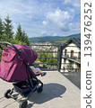 Toddler in a Stroller on a Terrace with Bukovel Mountain View 139476252