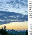 Scenic Sunset Over Carpathian Mountains with Blue Clouds and Dark Trees 139476254