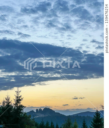 Scenic Sunset Over Carpathian Mountains with Blue Clouds and Dark Trees Scenic Sunset Over Carpathian Mountains with Blue Clouds and Dark Trees 139476254