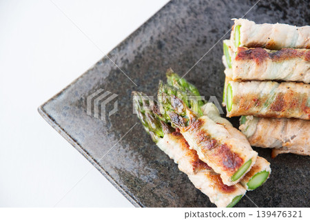Asparagus wrapped in meat on a plate Asparagus wrapped in meat on a plate 139476321