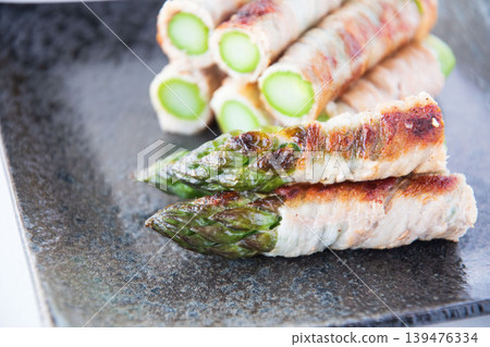 Asparagus wrapped in meat on a plate Asparagus wrapped in meat on a plate 139476334