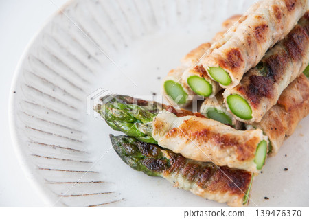 Asparagus wrapped in meat on a plate Asparagus wrapped in meat on a plate 139476370