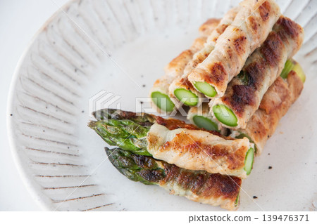 Asparagus wrapped in meat on a plate Asparagus wrapped in meat on a plate 139476371