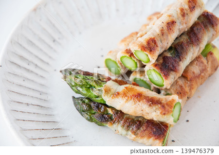 Asparagus wrapped in meat on a plate Asparagus wrapped in meat on a plate 139476379
