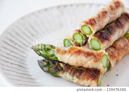 Asparagus wrapped in meat on a plate Asparagus wrapped in meat on a plate 139476380