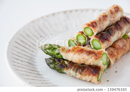 Asparagus wrapped in meat on a plate Asparagus wrapped in meat on a plate 139476385