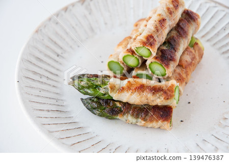 Asparagus wrapped in meat on a plate Asparagus wrapped in meat on a plate 139476387