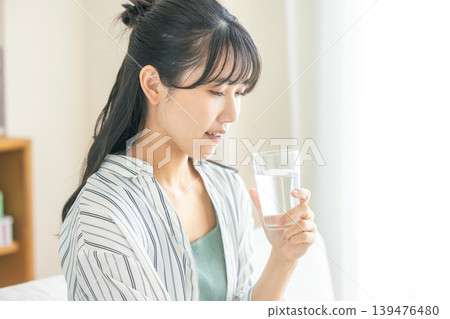 Young woman drinking water Young woman drinking water 139476480