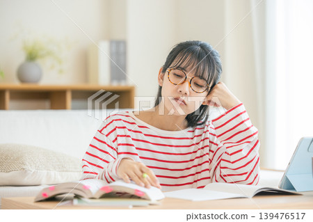 woman tired of studying woman tired of studying 139476517