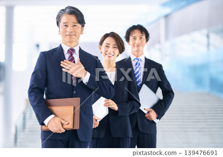 A Japanese businessman places his hand on his chest; a trustworthy and honest business team. A Japanese businessman places his hand on his chest; a trustworthy and honest business team. 139476691