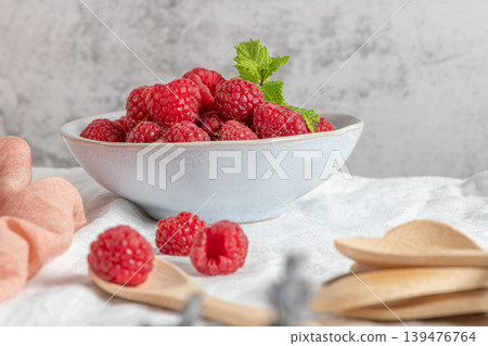 Bowl of delicious fresh ripe raspberries, closeup view 139476764