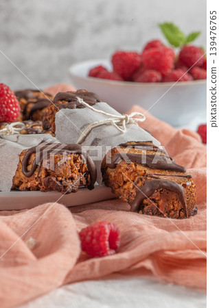 Cereal bars with raspberries on kitchen counter top. Cereal bars with raspberries on kitchen counter top. 139476765