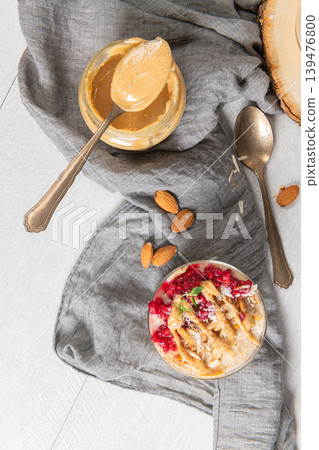 Breakfast oatmeal porridge with raspberries, almond, cinnamon, almond butter and coconut. Healthy breakfast delicious homemade english breakfast concept Breakfast oatmeal porridge with raspberries, almond, cinnamon, almond butter and coconut. Healthy breakfast delicious homemade english breakfast concept 139476800