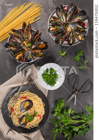 Homemade pasta spaghetti with mussels, peppers and parsley on rustic background. Sea food meal Homemade pasta spaghetti with mussels, peppers and parsley on rustic background. Sea food meal 139476802